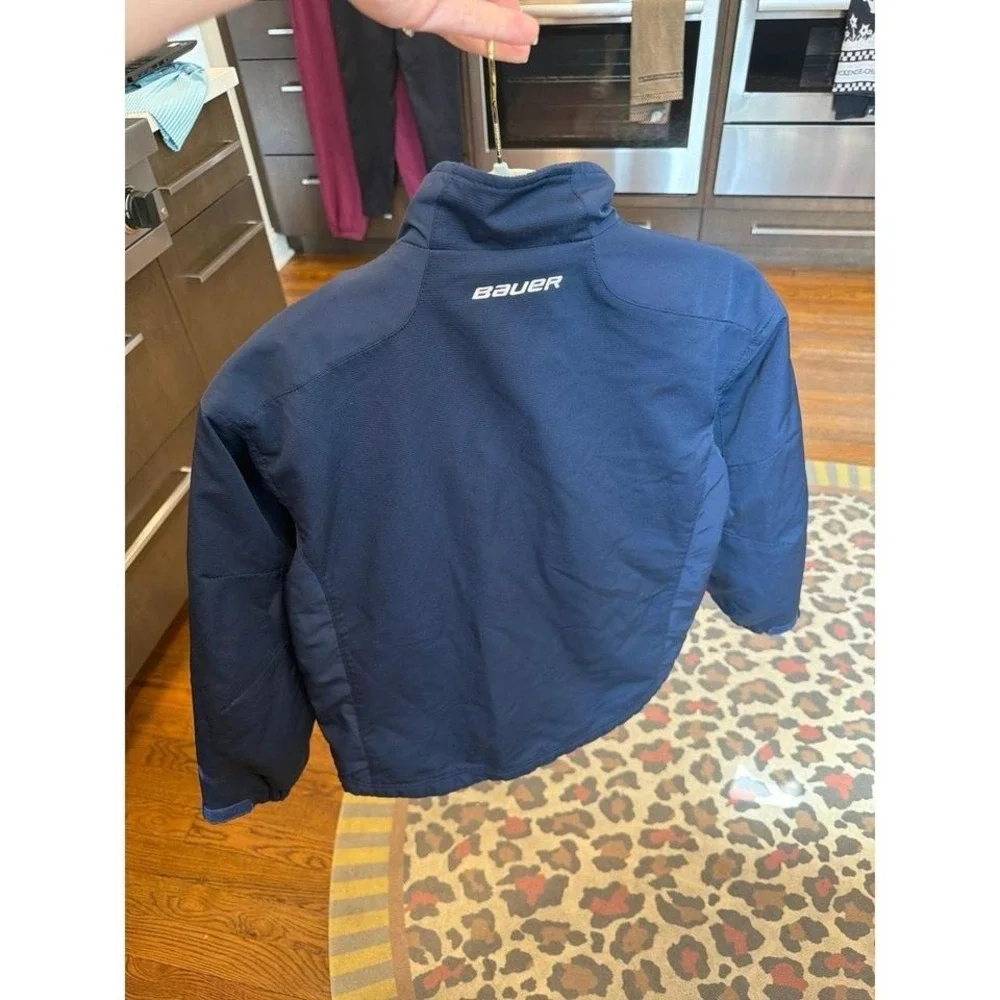 Bauer Team‎ youth warm-up jacket features white piping and a zippered fleece XS